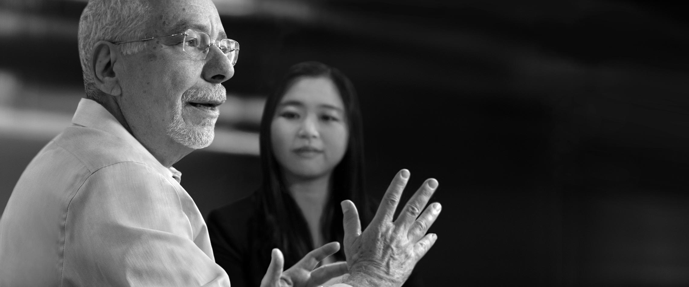 Pinney Associates experts Saul Shiffman and Sooyong Kim discuss pharmaceutical strategy at a conference table